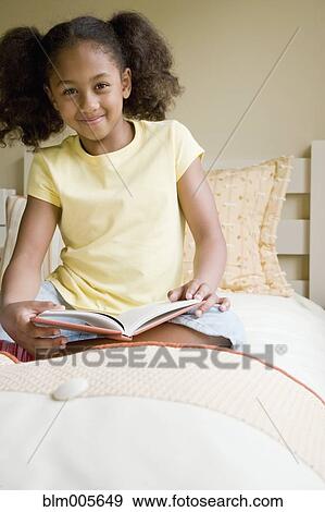African American girl reading book in bed View Large Photo Image Stock Photo - African American girl reading book in bed. Fotosearch