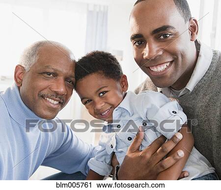 Stock Image - African American grandfather smiling with son and grandson. Fotosearch