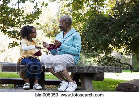 African American grandmother helping granddaughter wind yarn View Large Photo Image Stock Image - African American grandmother helping granddaughter wind yarn. Fotosearch