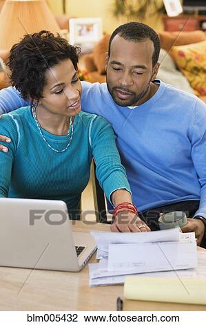 African American husband and wife paying bills together View Large Photo Image Stock Image - African American husband and wife paying bills together. Fotosearch