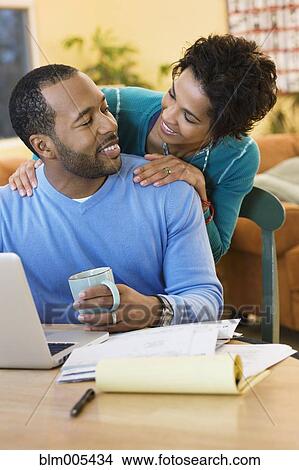 African American husband paying bills online View Large Photo Image Picture - African American husband paying bills online. Fotosearch