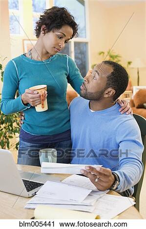 African American husband paying bills as wife watches View Large Photo Image Stock Image - African American husband paying bills as wife watches. Fotosearch