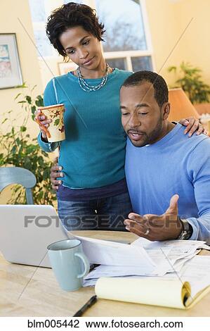 African American husband paying bills as wife watches View Large Photo Image Stock Image - African American husband paying bills as wife watches. Fotosearch
