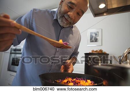 African American man cooking dinner on stove View Large Photo Image Stock Image - African American man cooking dinner on stove. Fotosearch