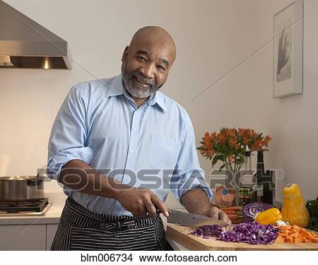 African American man cutting vegetables View Large Photo Image Picture - African American man cutting vegetables. Fotosearch