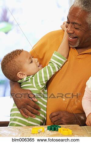 Stock Photography - African American man hugging grandson. Fotosearch