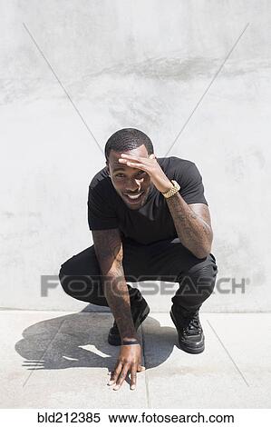 Stock Photography - African American man smiling on city street. Fotosearch