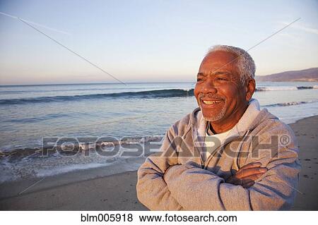 African American man standing on beach View Large Photo Image Stock Photo - African American man standing on beach. Fotosearch