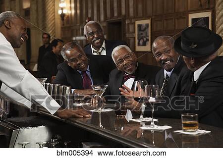 Picture - African American men drinking at bar. Fotosearch