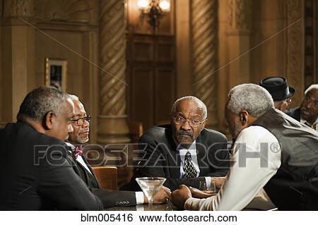 Stock Photograph - African American men drinking in bar. Fotosearch