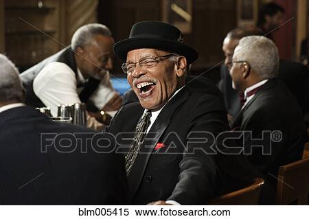 Stock Photography - African American men drinking in bar. Fotosearch
