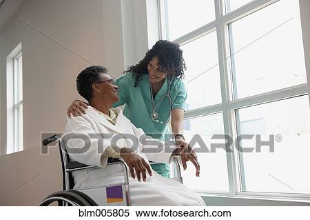 African American nurse checking on patient in wheel chair View Large Photo Image Stock Photography - African American nurse checking on patient in wheel chair. Fotosearch