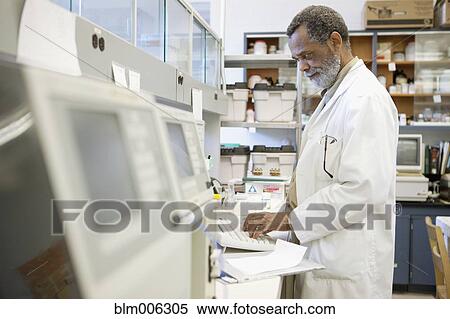 Stock Photography - African American scientist working in laboratory. Fotosearch