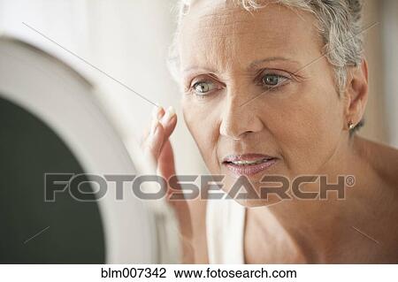 African American woman applying makeup View Large Photo Image Stock Image - African American woman applying makeup. Fotosearch