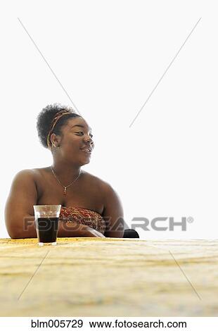 African American woman drinking soda at table View Large Photo Image Stock Photo - African American woman drinking soda at table. Fotosearch
