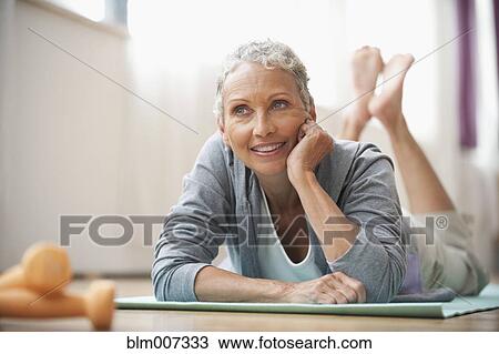 African American woman laying on exercise mat View Large Photo Image Stock Image - African American woman laying on exercise mat. Fotosearch