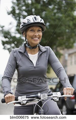 African American woman riding bicycle in city View Large Photo Image Stock Photography - African American woman riding bicycle in city. Fotosearch
