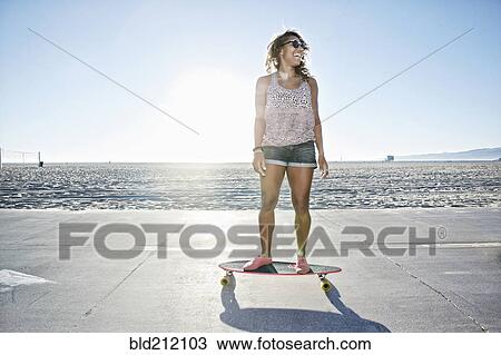 African American woman riding longboard on beach View Large Photo Image Stock Image - African American woman riding longboard on beach. Fotosearch
