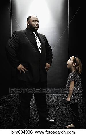 African bouncer intimidating young girl View Large Photo Image Stock Photograph - African bouncer intimidating young girl. Fotosearch