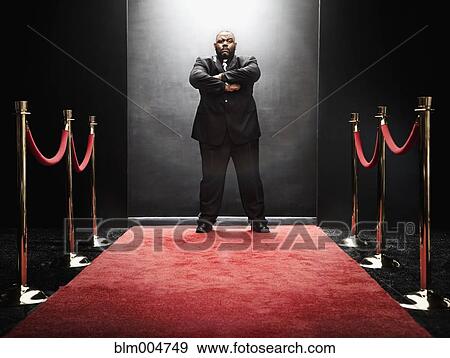 African bouncer protecting entrance at the end of red carpet View Large Photo Image Stock Photo - African bouncer protecting entrance at the end of red carpet. Fotosearch