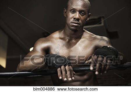 Stock Photograph - African boxer leaning on ropes. Fotosearch