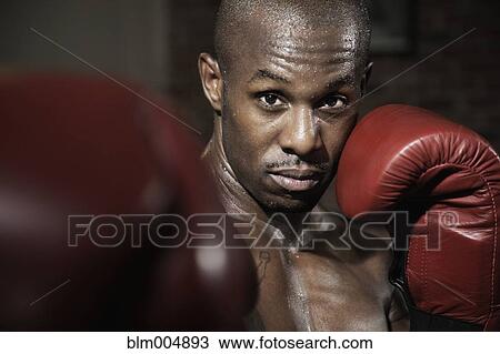 Stock Image - African boxer punching. Fotosearch