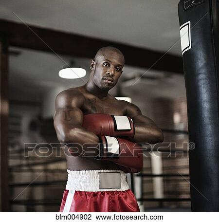 Stock Image - African boxer with arms crossed. Fotosearch
