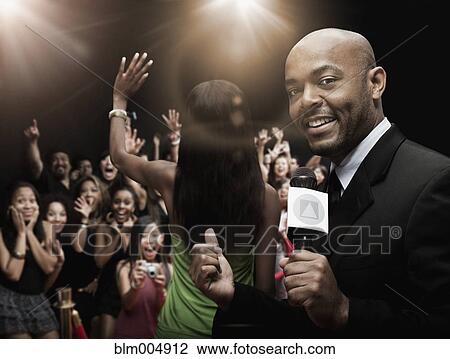 Stock Image - African broadcaster at red carpet event. Fotosearch