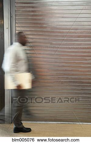 Stock Photograph - African businessman hurrying in office. Fotosearch