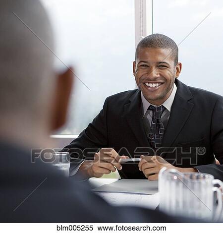 Stock Photography - African businessman in meeting. Fotosearch