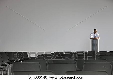 Stock Image - African businessman preparing for speech. Fotosearch