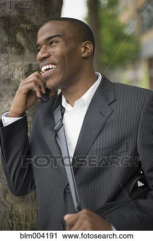 African businessman talking on cell phone View Large Photo Image Stock Image - African businessman talking on cell phone. Fotosearch