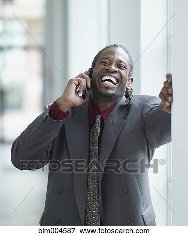 Stock Photo - African businessman talking on cell phone. Fotosearch