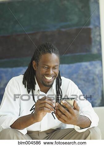 African businessman using electronic organizer View Large Photo Image Stock Photograph - African businessman using electronic organizer. Fotosearch