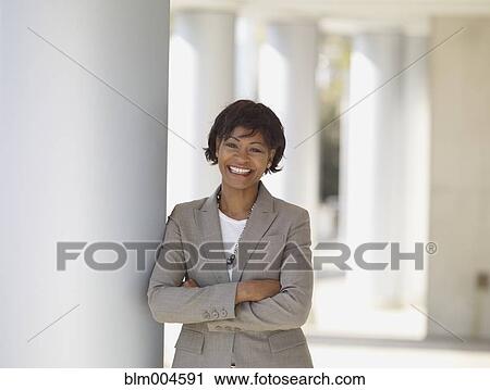 African businesswoman leaning against pillar View Large Photo Image Stock Image - African businesswoman leaning against pillar. Fotosearch