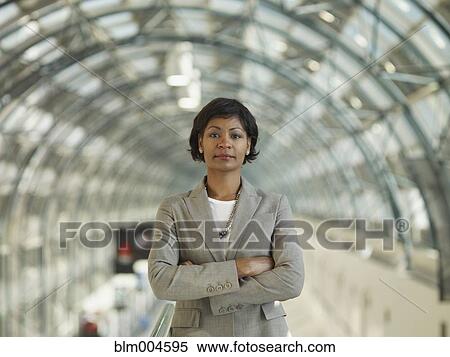 Stock Photography - African businesswoman standing with arms crossed. Fotosearch