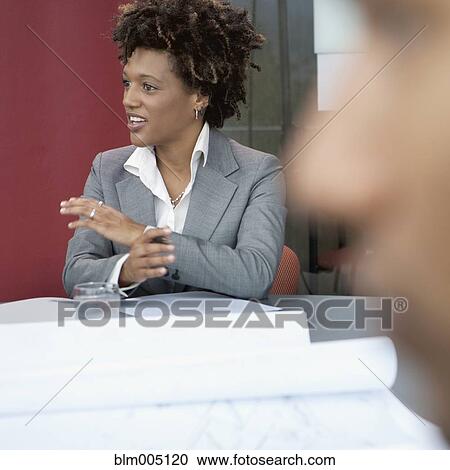 Stock Image - African businesswoman talking. Fotosearch