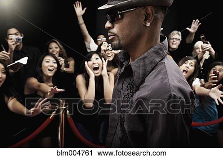 Stock Image - African celebrity arriving on red carpet. Fotosearch