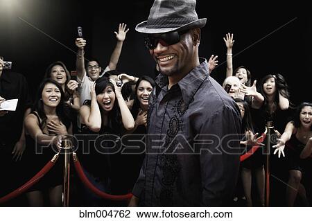 Stock Image - African celebrity arriving on red carpet. Fotosearch