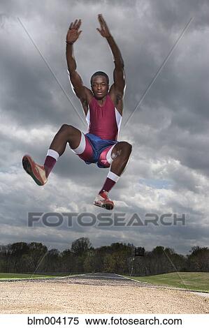 Stock Photography - African man long jumping. Fotosearch