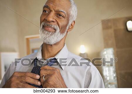 African man putting on tie View Large Photo Image Stock Image - African man putting on tie. Fotosearch