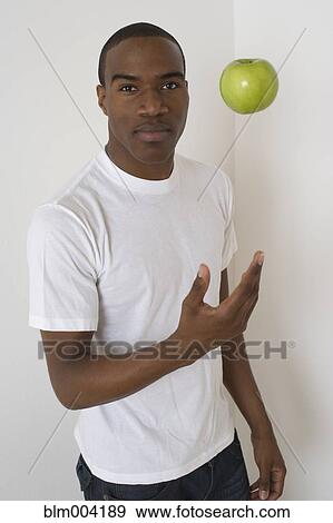 African man tossing apple View Large Photo Image Stock Photo - African man tossing apple. Fotosearch