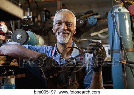 African man working in metal shop View Large Photo Image Stock Photo - African man working in metal shop. Fotosearch