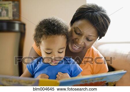 Stock Photography - African mother reading to young son. Fotosearch