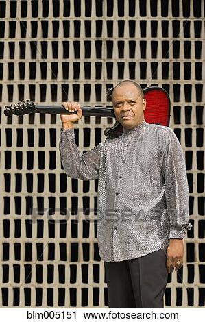 African musician holding electric guitar View Large Photo Image Stock Image - African musician holding electric guitar. Fotosearch