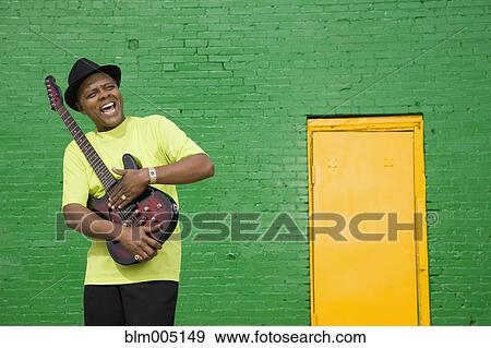 African musician holding electric guitar View Large Photo Image Stock Photo - African musician holding electric guitar. Fotosearch