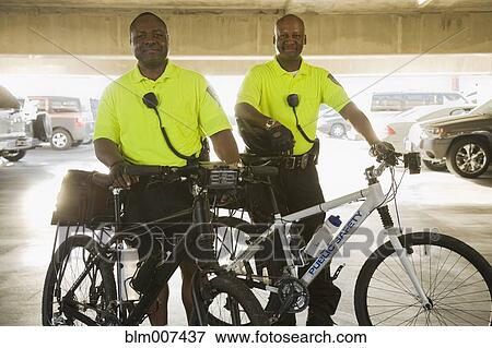 Stock Photo - African police officers on bicycles. Fotosearch