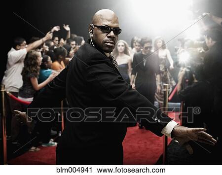 Stock Image - African security guard at red carpet event. Fotosearch