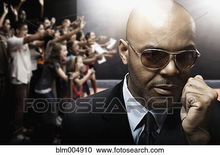 Stock Image - African security guard talking into microphone. Fotosearch