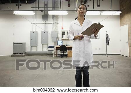 African technician holding clipboard in warehouse View Large Photo Image Stock Image - African technician holding clipboard in warehouse. Fotosearch